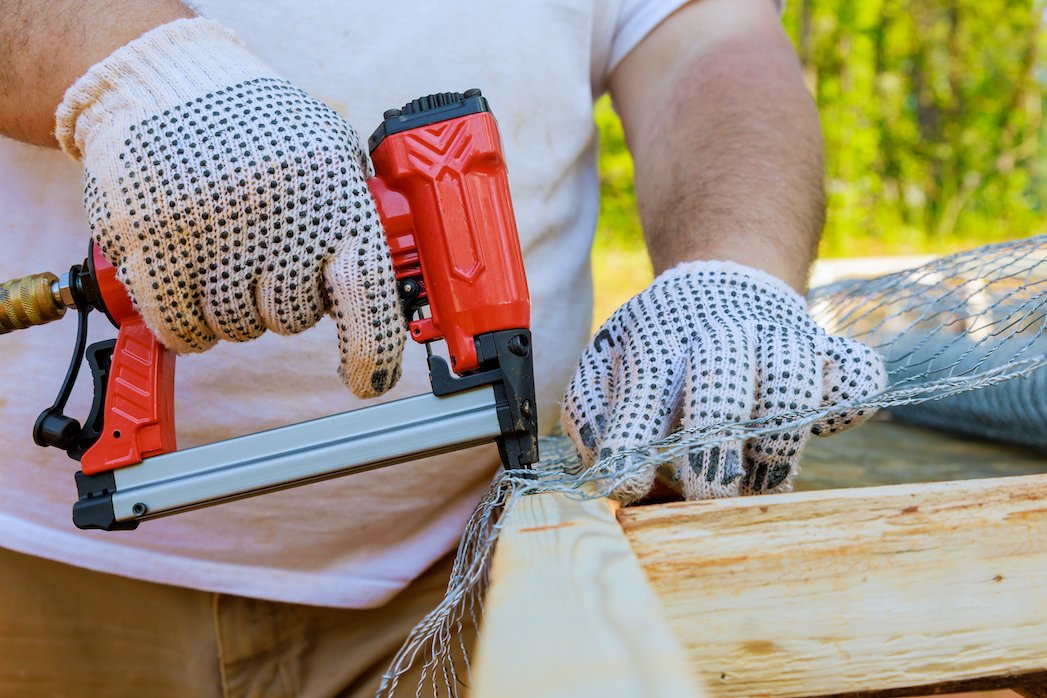 An employee nailed a metal mesh to a wooden frame as part of his work